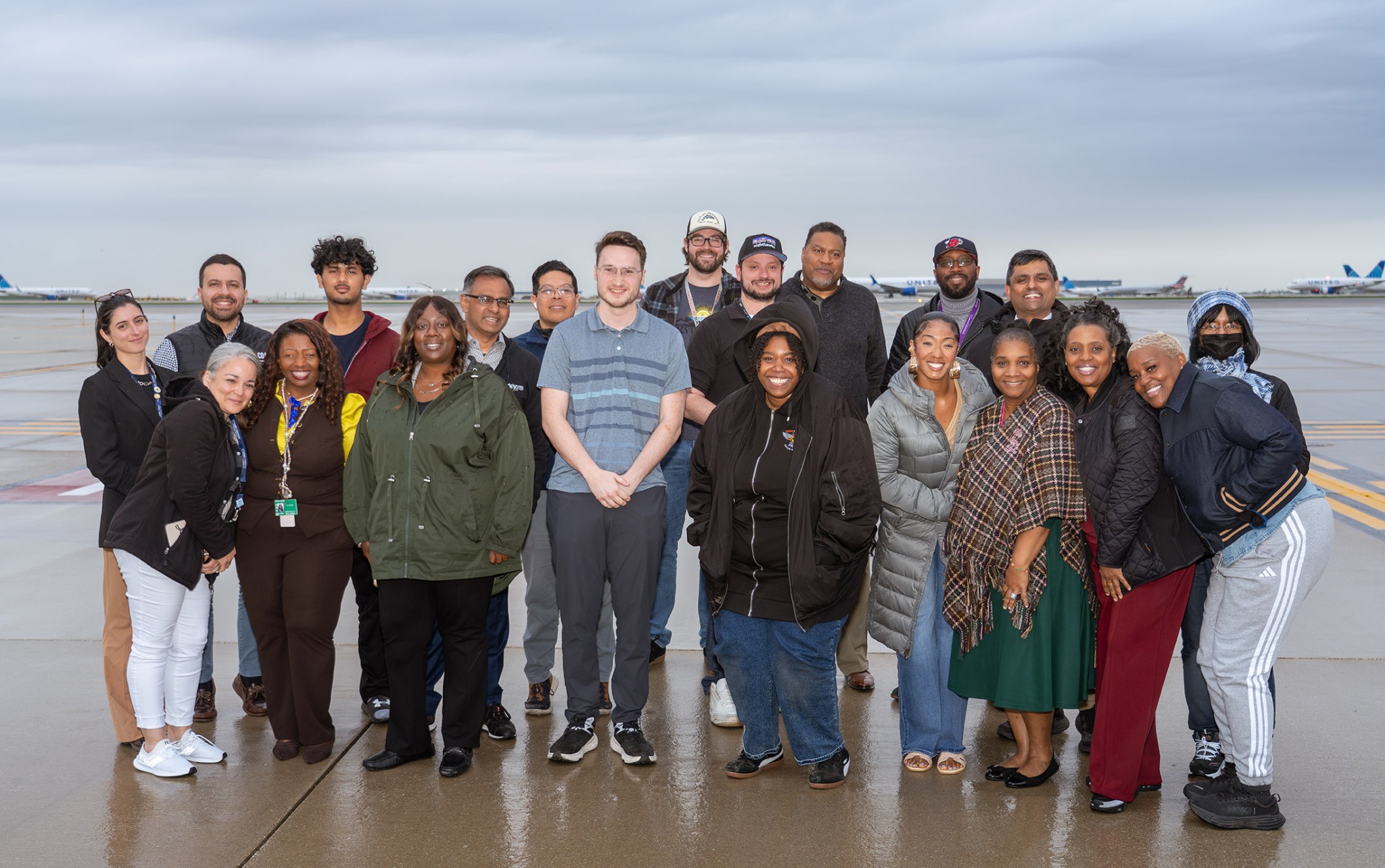 Aviation Career Pathways Program participants and airport professionals standing together on an airport ramp